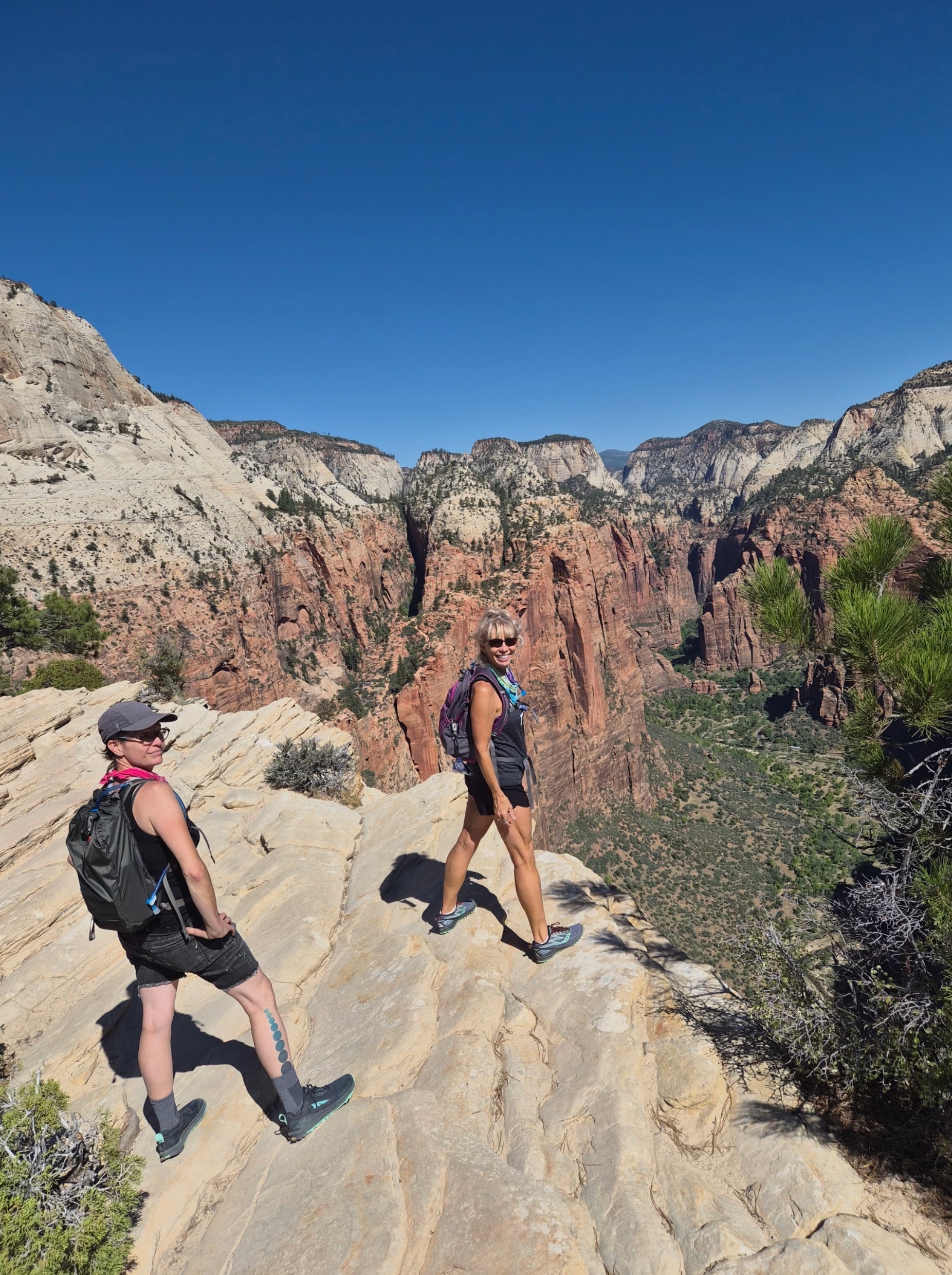 Michelle and her bad ass big sister at the very tippy toppy edge of Angel's Landing, Zion NP